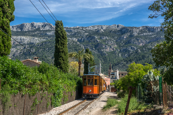 Sóller tram with the Serra de Tramuntana mountains as a backdrop.